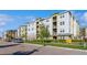 Exterior of a multi-story condo building featuring light blue, yellow, and white paint scheme at 7517 Laureate Blvd # 4103, Orlando, FL 32827