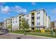 Exterior of a multi-story condo building featuring light blue, yellow, and white paint scheme at 7517 Laureate Blvd # 4103, Orlando, FL 32827