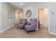 Inviting foyer with stylish chairs and decor leading to the bathroom at 7517 Laureate Blvd # 4103, Orlando, FL 32827