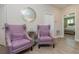 Elegant foyer with stylish chairs and decor leading to the main bedroom at 7517 Laureate Blvd # 4103, Orlando, FL 32827