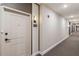 Condo hallway with neutral colors and unit number 4103 on the wall near the unit entry door at 7517 Laureate Blvd # 4103, Orlando, FL 32827