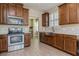 Modern kitchen featuring stainless steel appliances, wooden cabinets, and marble countertops at 7517 Laureate Blvd # 4103, Orlando, FL 32827