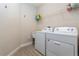 Functional laundry room with washer, dryer, utility sink and overhead shelving at 7517 Laureate Blvd # 4103, Orlando, FL 32827