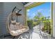 Relaxing patio area featuring a hanging egg chair and secure gated entrance at 7517 Laureate Blvd # 4103, Orlando, FL 32827