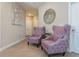 A stylish sitting area with two elegant purple chairs and decorative wall art at 7517 Laureate Blvd # 4103, Orlando, FL 32827