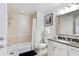 Well-lit bathroom featuring a shower over tub and a single sink granite vanity at 7651 Whisper Way # 204, Reunion, FL 34747