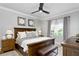 Bedroom featuring wood floors, an upholstered bench, a ceiling fan, and a large window at 7651 Whisper Way # 204, Reunion, FL 34747