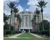 Elegant condo resort with palm tree lined entrance and manicured lawn at 7651 Whisper Way # 204, Reunion, FL 34747