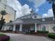 Beautiful clubhouse entrance with stone pillars and well landscaped garden beds at 7651 Whisper Way # 204, Reunion, FL 34747