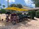 A lineup of vibrant rental bikes with cheerful yellow canopies are available for easy transportation and exploration at 7651 Whisper Way # 204, Reunion, FL 34747