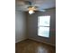 Bedroom with wood-look floors, a ceiling fan, and a window at 7706 Country Pl # 7706, Winter Park, FL 32792