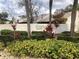 Beautiful Goldenrod Villas sign with mature landscaping and palm trees on a sunny day at 7706 Country Pl # 7706, Winter Park, FL 32792