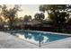 Community pool featuring a well-maintained pool with nearby trees and lounge chairs at 7706 Country Pl # 7706, Winter Park, FL 32792