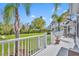 Spacious back porch with outdoor furniture and scenic views of the lush backyard and landscaping at 807 Oak Shadows Rd, Celebration, FL 34747