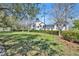 Lush backyard featuring a well-manicured lawn, mature trees, and manicured hedges at 807 Oak Shadows Rd, Celebration, FL 34747