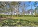 Backyard featuring lush lawn, manicured hedges, and beautiful trees at 807 Oak Shadows Rd, Celebration, FL 34747