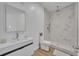 Modern bathroom with walk-in shower with tile, white vanity and natural light at 807 Oak Shadows Rd, Celebration, FL 34747