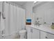 Well-lit bathroom featuring a shower, toilet and sink at 807 Oak Shadows Rd, Celebration, FL 34747