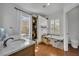 Luxurious bathroom featuring marble countertops, a soaking tub, and a separate shower at 807 Oak Shadows Rd, Celebration, FL 34747