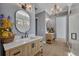 Spacious bathroom featuring a light wood double vanity and modern fixtures at 807 Oak Shadows Rd, Celebration, FL 34747