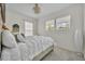 Bright bedroom with a large bed, plush pillows and multiple windows at 807 Oak Shadows Rd, Celebration, FL 34747