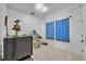 Bright bedroom with a blue striped curtain, white walls, carpeted floors, and a decorative vanity at 807 Oak Shadows Rd, Celebration, FL 34747