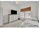 Comfortable bedroom featuring neutral carpet, white furnishings and a large window offering natural light at 807 Oak Shadows Rd, Celebration, FL 34747