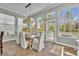 Charming dining area with tile flooring, a wooden table, and many windows overlooking the outside at 807 Oak Shadows Rd, Celebration, FL 34747