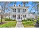 Charming two-story home featuring a spacious double porch, complemented by well-manicured landscaping and a welcoming walkway at 807 Oak Shadows Rd, Celebration, FL 34747