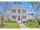 Charming two-story home with a welcoming front porch and manicured landscaping at 807 Oak Shadows Rd, Celebration, FL 34747