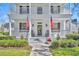 Welcoming front porch featuring rocking chairs, an American flag, and a wreath at 807 Oak Shadows Rd, Celebration, FL 34747