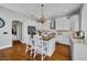 Bright kitchen featuring white cabinets, a wooden island with seating, and stainless steel appliances at 807 Oak Shadows Rd, Celebration, FL 34747