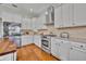 Modern kitchen showcasing white cabinetry, stainless steel appliances, and hardwood flooring at 807 Oak Shadows Rd, Celebration, FL 34747