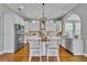 Elegant kitchen featuring white cabinetry, a central island with seating, and stainless steel appliances at 807 Oak Shadows Rd, Celebration, FL 34747