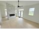 Bright, open living area features light wood floors and a striking stone fireplace at 807 Oak Shadows Rd, Celebration, FL 34747