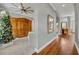 View of the living room with hardwood floors, a wooden entertainment center, and a decorated Christmas tree at 807 Oak Shadows Rd, Celebration, FL 34747