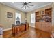 Home office with wood floors, a built-in bookcase, and a large desk at 807 Oak Shadows Rd, Celebration, FL 34747