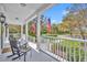 Relaxing covered porch featuring comfortable seating and views of the landscaped front yard at 807 Oak Shadows Rd, Celebration, FL 34747