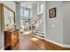 Bright foyer features a staircase, hardwood flooring, and a view into the living area at 807 Oak Shadows Rd, Celebration, FL 34747