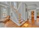 Bright foyer features a staircase with wooden banister and hardwood flooring at 807 Oak Shadows Rd, Celebration, FL 34747