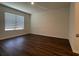 Bright bedroom with wood flooring, a large window, and a neutral color scheme at 956 Brooklet Dr, Davenport, FL 33837