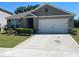 Charming single-story home featuring a well-manicured lawn and a spacious two-car garage at 956 Brooklet Dr, Davenport, FL 33837