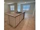 Spacious kitchen island featuring granite countertops, stainless steel dishwasher, and views to the living area at 956 Brooklet Dr, Davenport, FL 33837