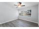 Neutral bedroom featuring gray wood flooring, a ceiling fan, and a large window at 1117 N Hart Blvd, Orlando, FL 32818