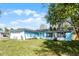 Inviting light blue single-story home with an attached garage and a well-maintained lawn at 1117 N Hart Blvd, Orlando, FL 32818