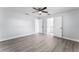 Spacious main bedroom with wood flooring, a ceiling fan, and an ensuite bathroom at 1117 N Hart Blvd, Orlando, FL 32818