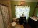 Cozy bathroom featuring patterned shower curtain, toilet, vanity, and decorative accents at 11213 River Grove Dr, Orlando, FL 32817
