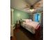 Cozy bedroom features a ceiling fan, patterned bedding, and wood furnishings at 11213 River Grove Dr, Orlando, FL 32817