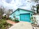 Charming home with a blue exterior, tidy landscaping, and an attached garage at 11213 River Grove Dr, Orlando, FL 32817