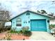 Charming single-story home with a bright blue exterior and well-maintained landscaping at 11213 River Grove Dr, Orlando, FL 32817